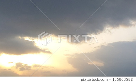A sky with light shining through the gaps in the clouds 135963598