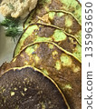 Delicious green pancakes served with herbs and creamy dip for breakfast 135963650