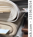 Rolls of soft materials stacked in a workshop for crafting projects 135963654