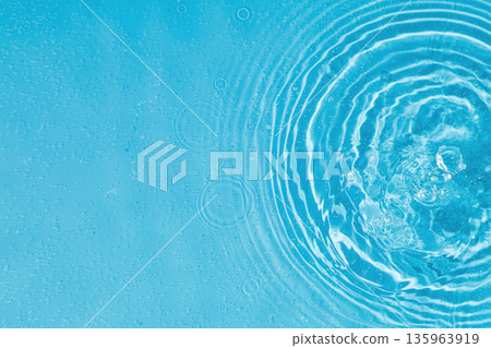 drops on water with circles on a blue background drops on water with circles on a blue background 135963919