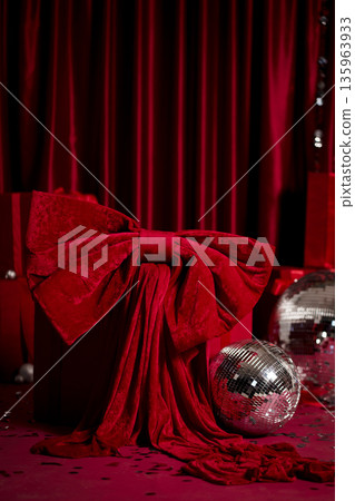 Red glamorous Christmas party scene with gifts, disco balls and silver tinsel 135963933