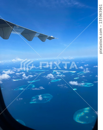 A plane is flying through the sky with a tail wing A plane is flying through the sky with a tail wing 135963961