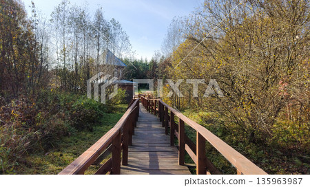 A wooden bridge with trees in the background A wooden bridge with trees in the background 135963987