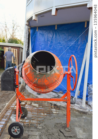 Portable Concrete Mixer on Construction Site with Rebar Reinforcement  135964048