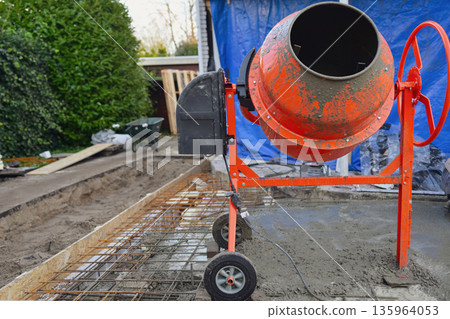 Portable Concrete Mixer on Construction Site with Rebar Reinforcement  135964053