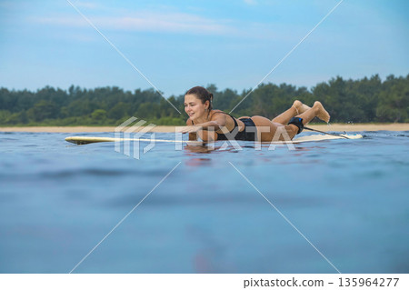 Serene Scene Of Woman Navigating Shallow Turquoise Waters Peacefully Serene Scene Of Woman Navigating Shallow Turquoise Waters Peacefully 135964277