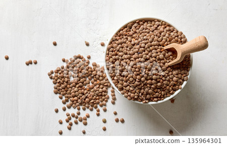 bowl of dried red lentiles on white kitchen table 135964301