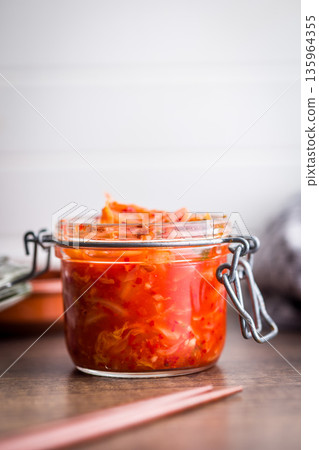 Fermented cabbage. Kimchi. Korean food in jar on wooden table. Fermented cabbage. Kimchi. Korean food in jar on wooden table. 135964355
