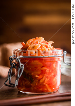 Fermented cabbage. Kimchi. Korean food in jar on wooden table. Fermented cabbage. Kimchi. Korean food in jar on wooden table. 135964361