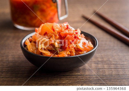 Fermented cabbage. Kimchi. Korean food in bowl on wooden table. Fermented cabbage. Kimchi. Korean food in bowl on wooden table. 135964368
