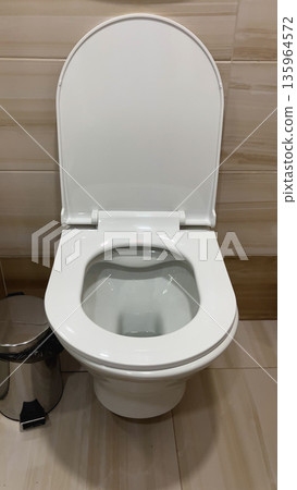White toilet in the toilet room. 135964572