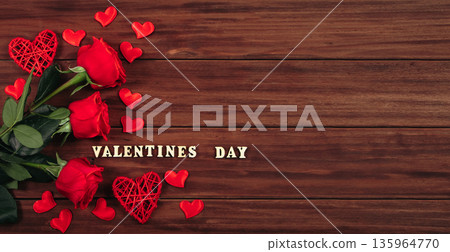 Red roses and hearts on a dark wooden background. Valentine's day postcard concept. Red roses and hearts on a dark wooden background. Valentine's day postcard concept. 135964770