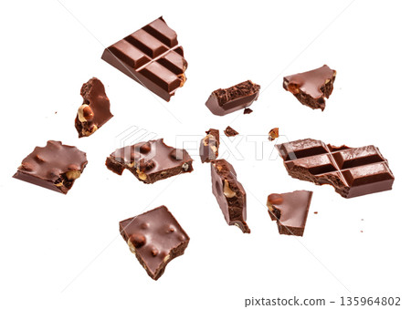 Broken milk chocolate pieces with nuts isolated on white background Broken milk chocolate pieces with nuts isolated on white background 135964802