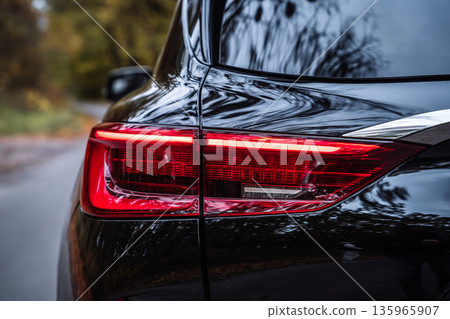 Rear Car Taillight with Red LED Light on Road Rear Car Taillight with Red LED Light on Road 135965907