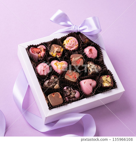 Chocolate candies, assorted chocolates in a white gift box with lavender ribbon 135966108
