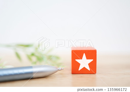 Orange block with star symbol. Image of rating and attention. Orange block with star symbol. Image of rating and attention. 135966172