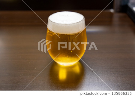 Beer poured into a glass Beer poured into a glass 135966335