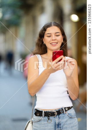 Girl takes selfies during outdoor walk Girl takes selfies during outdoor walk 135966823