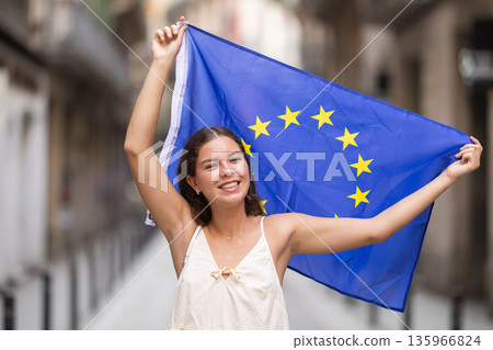 Young woman with EU flag on city street Young woman with EU flag on city street 135966824