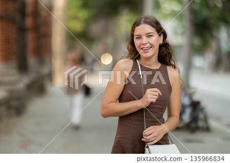 woman stands in front of a fence in Barcelona woman stands in front of a fence in Barcelona 135966834