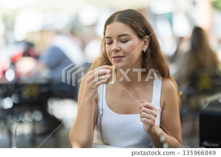 Young woman enjoying summer coffee break outdoors 135966849