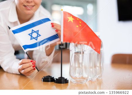 Flags of Israel and China stand on negotiating table in office Flags of Israel and China stand on negotiating table in office 135966922