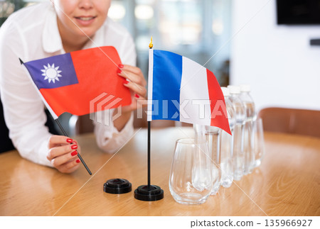 Flags of Taiwan and France stand on negotiating table in office Flags of Taiwan and France stand on negotiating table in office 135966927