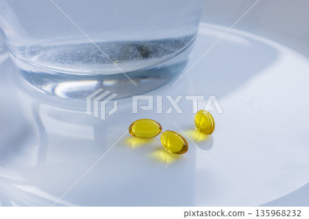 Vitamins and pills with glass of water 135968232