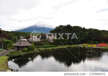 Old thatched roof houses and Mount Fuji reflected in the pond | An original Japanese landscape Old thatched roof houses and Mount Fuji reflected in the pond | An original Japanese landscape 135968341