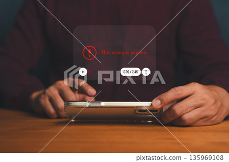 Person holding smartphone with private video notification, symbolizing digital privacy, content restriction, data protection, and online security awareness in modern media platforms and networks. 135969108