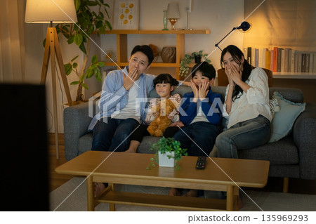 Family watching TV Family watching TV 135969293