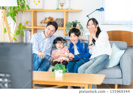Family watching TV Family watching TV 135969344