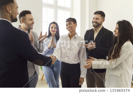 Handshake in recognition of business leader and businesswoman, welcome to new employee in office Handshake in recognition of business leader and businesswoman, welcome to new employee in office 135969374