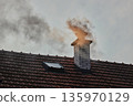 Smoking Chimney on a Roof 135970129