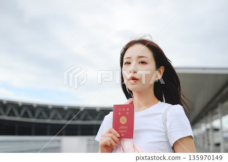 一名女子在機場手持護照。照片由關西國際機場(KIX)提供。 一名女子在機場手持護照。照片由關西國際機場(KIX)提供。 135970149