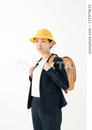An adult woman carrying a school bag An adult woman carrying a school bag 135970632