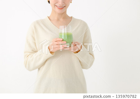 Middle-aged woman with a drink Middle-aged woman with a drink 135970782