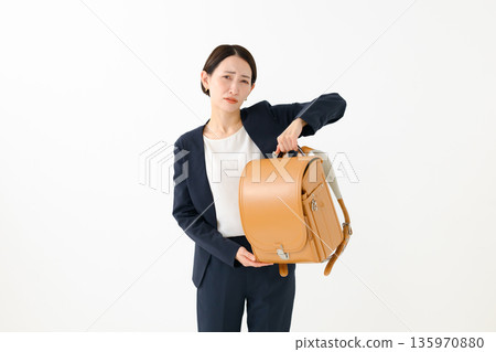 A woman with a school bag 135970880