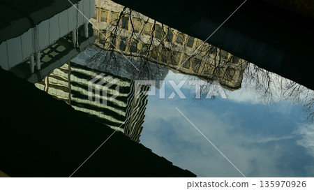 Shadow of a building reflected on the water 135970926