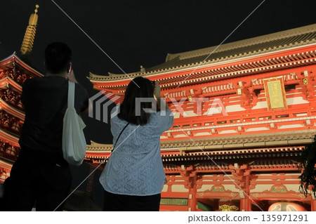 Tourists taking photos of the illuminated Hozomon Gate at Sensoji Temple 135971291