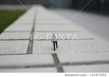iature Figure Riding Scooter Across Large White Steps iature Figure Riding Scooter Across Large White Steps 135971852