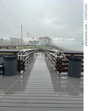 View of the entrance to the beach on rain. Destin, USA. View of the entrance to the beach on rain. Destin, USA. 135972201