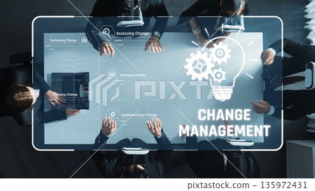 Visual Representation of Change Management Processes featuring a Diverse Group Collaborating Around a High-Tech Table with Infographic Elements. Raster 135972431