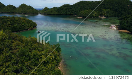 Aerial drone view of peaceful landscape of clear waters with forested islets in Sambulawan known as Tinagong Dagat in Sipalay, Negros Occidental, Philippines Aerial drone view of peaceful landscape of clear waters with forested islets in Sambulawan known as Tinagong Dagat in Sipalay, Negros Occidental, Philippines 135972475