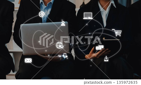 Business professionals working with technology, laptop, tablet, modern office, digital communication, networking, and online shopping concepts in focus. Raster 135972635