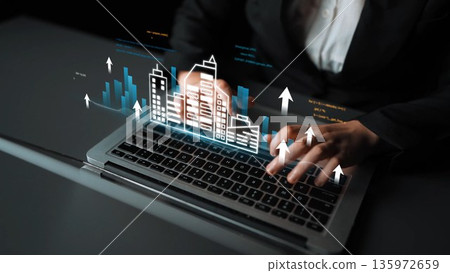 Professional Business Person Operating Laptop with Digital Cityscape and Graph Metrics, Symbolizing Growth and Innovation in Technology Sector Gluon Professional Business Person Operating Laptop with Digital Cityscape and Graph Metrics, Symbolizing Growth and Innovation in Technology Sector Gluon 135972659