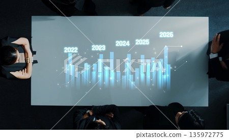 Business Meeting with Data Analysis on Projected Growth Graph for Years 2022 to 2026 in Modern Office Setting. Raster Business Meeting with Data Analysis on Projected Growth Graph for Years 2022 to 2026 in Modern Office Setting. Raster 135972775
