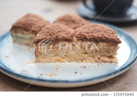 Turkish baklava served on a plate with layers and chocolate dust Turkish baklava served on a plate with layers and chocolate dust 135972840