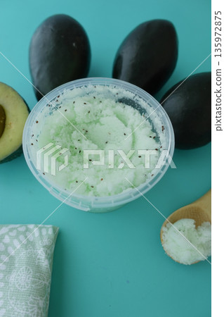 Homemade avocado scrub on a light blue surface 135972875
