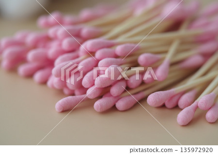 Colorful cotton swabs placed on a flat surface Colorful cotton swabs placed on a flat surface 135972920